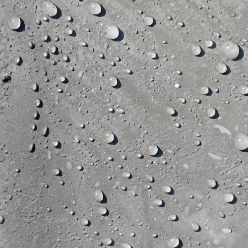 Water beaded up on sealed cement surface.